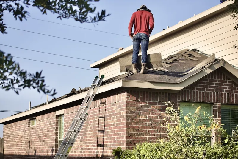 Professional roofer working on a residential roof in Downtown Saugus
